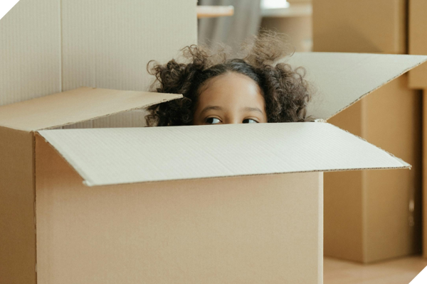 Girl Playing Inside Packing Box CROP